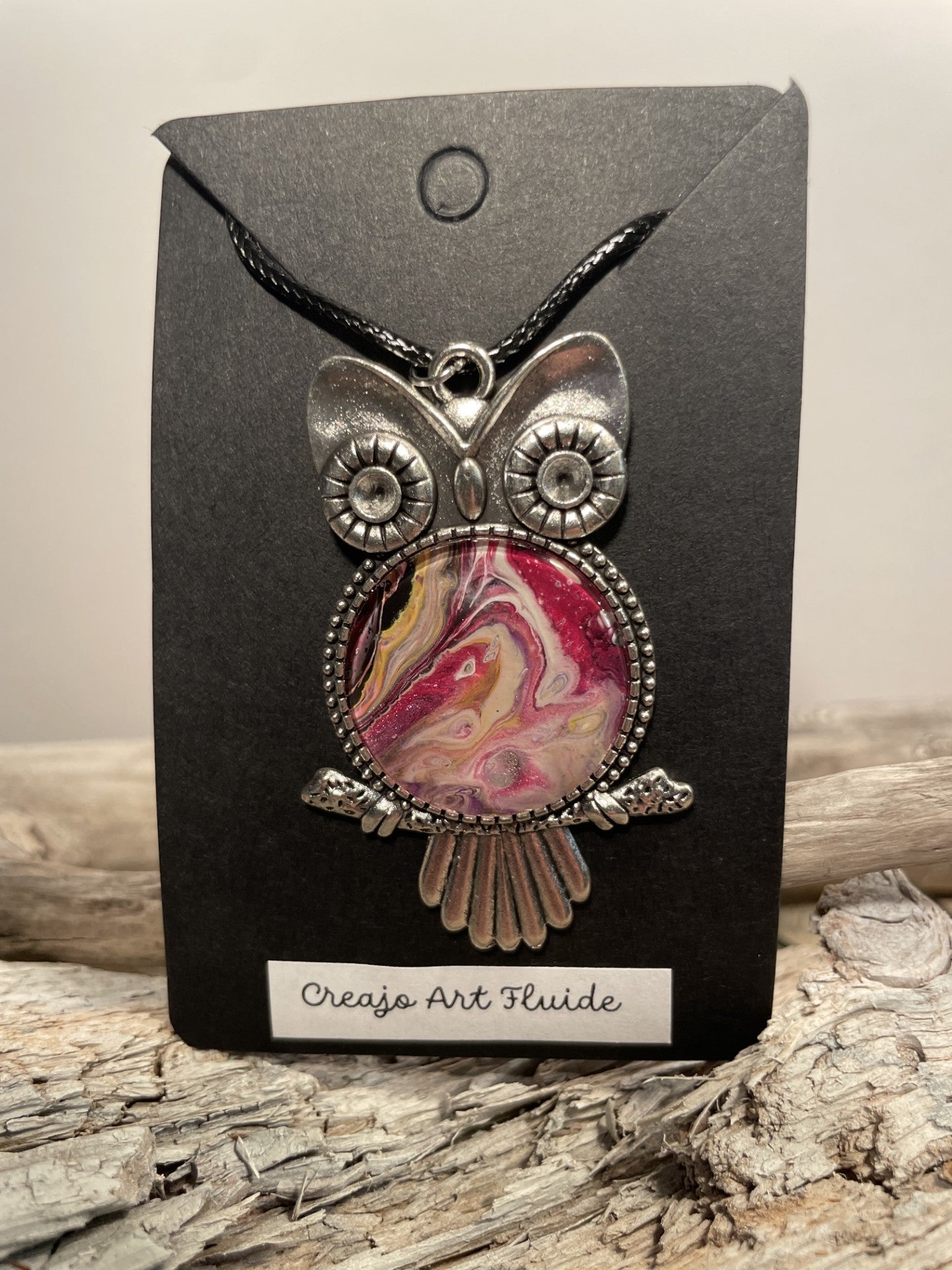 Pendant necklace in the shape of pink and beige owls