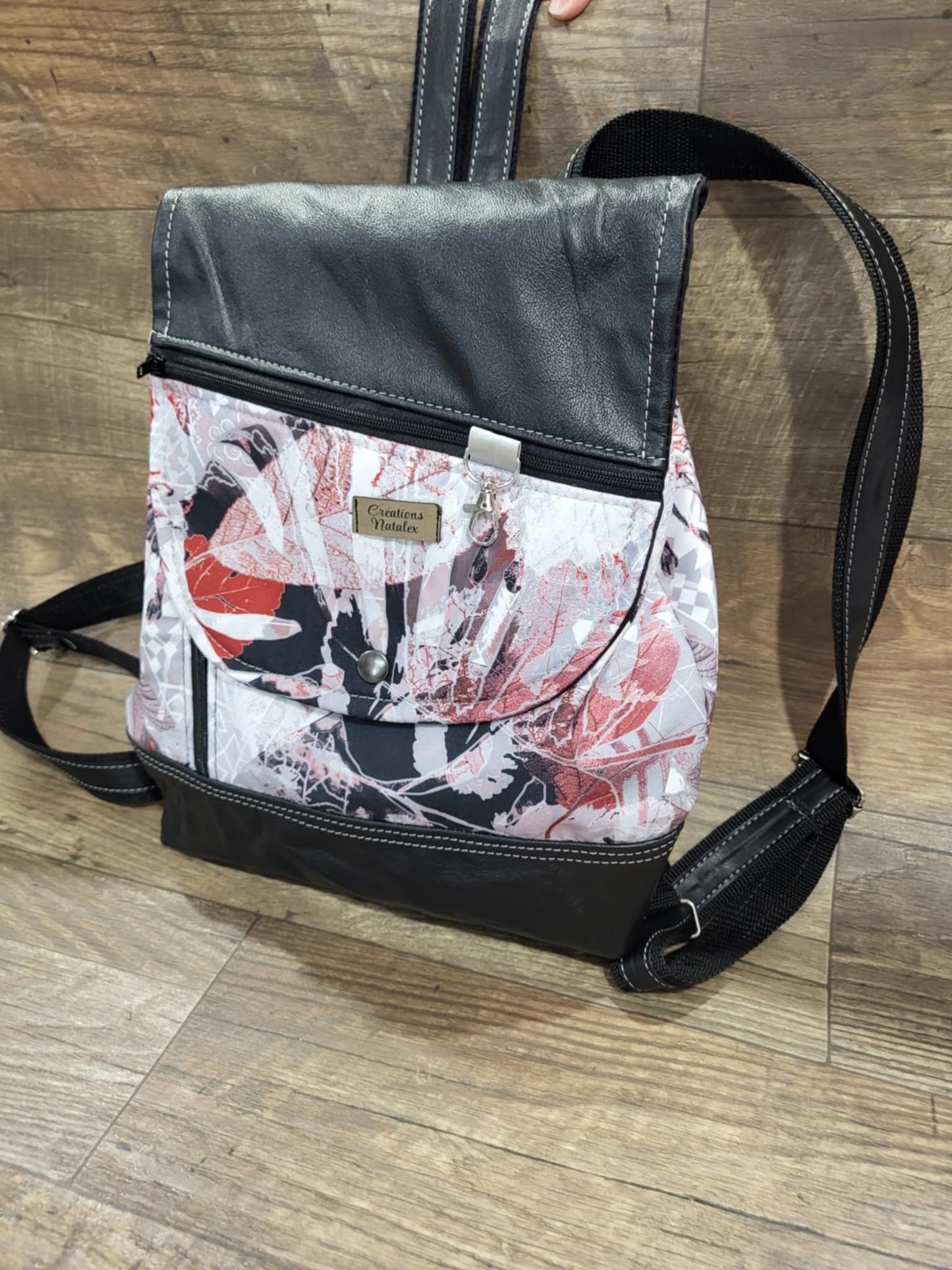 Backpack with red foliage flap and black genuine leather