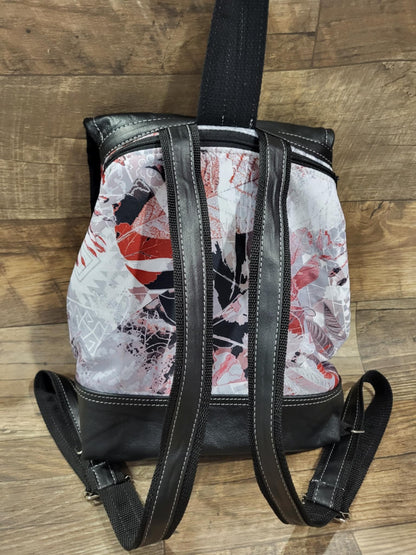 Backpack with red foliage flap and black genuine leather