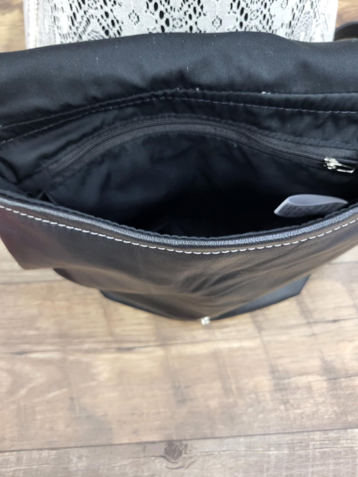 Black leather handbag with flap